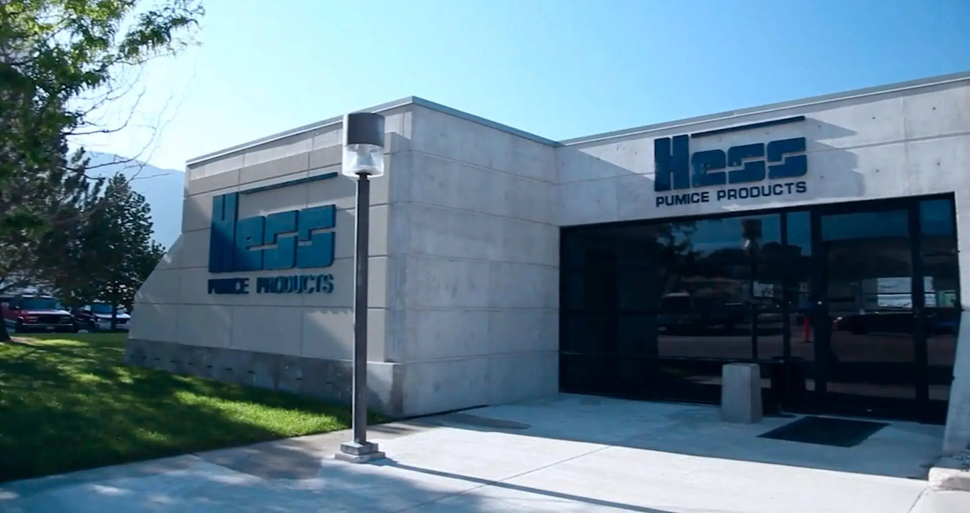 Building with 'Ness Pumps Products' logo on a clear day