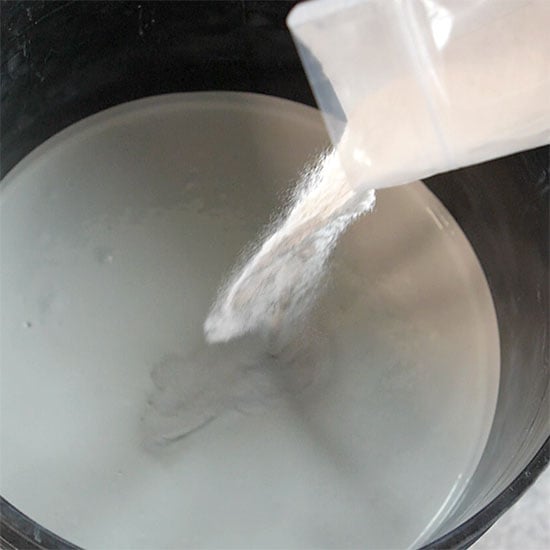 Dimension Grit (pumice texturizer) being poured into a primer